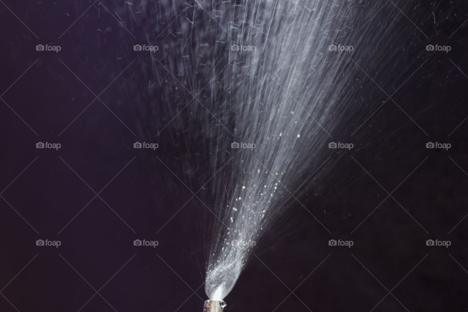 Spraying water dark background 