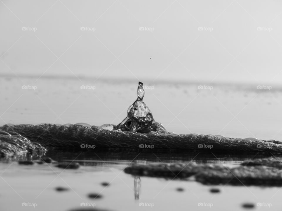 The motion of water as it bursts forth through the sand.