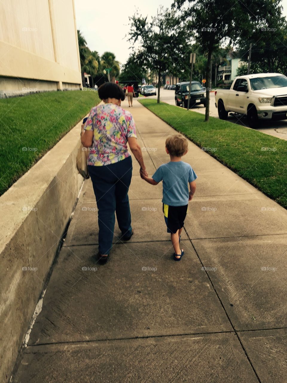 My grandmother and nephew walking down the sidewalk