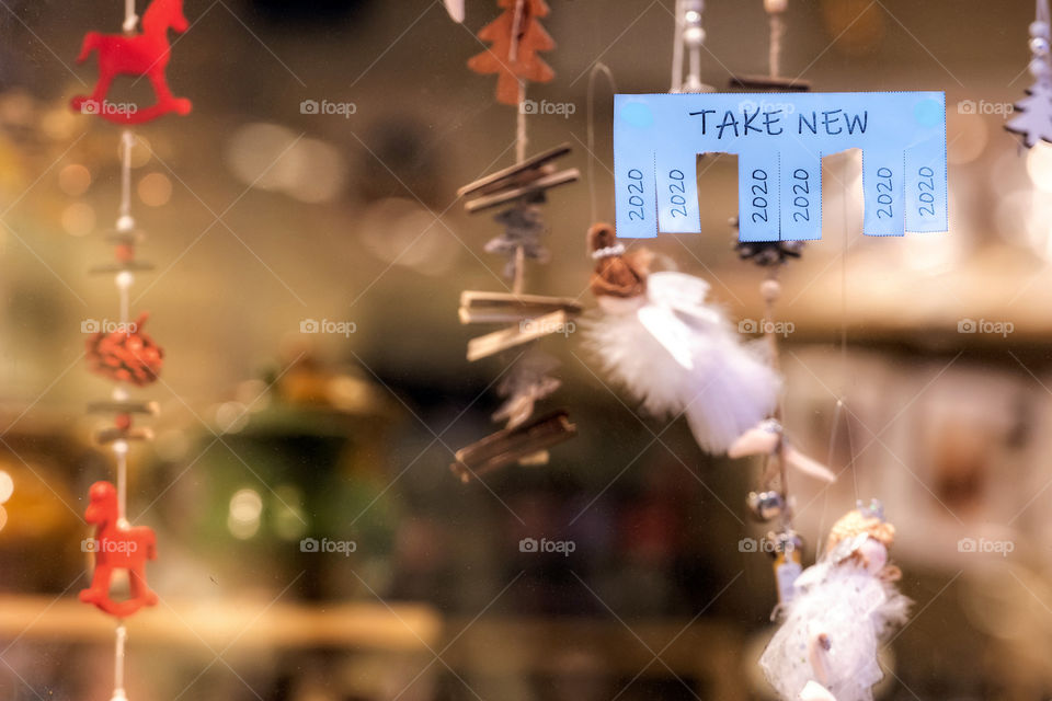 Christmas shop window with paper with the phrase: Take New and with a 2020 sign ready to be tore off