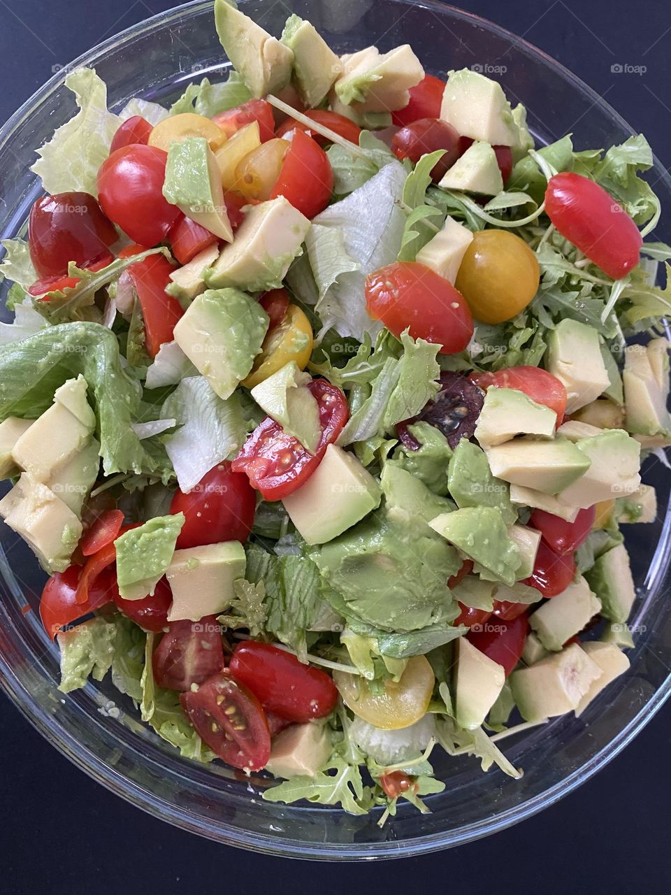 Healthy salad of cherry tomatoes, avocado, lettuce 