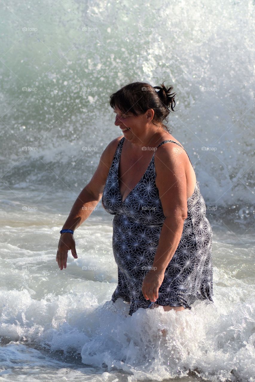 Happy mature woman enjoying in sea