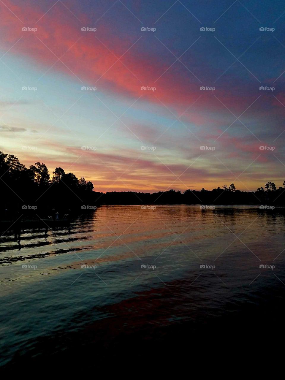 pink morning skies over lake.