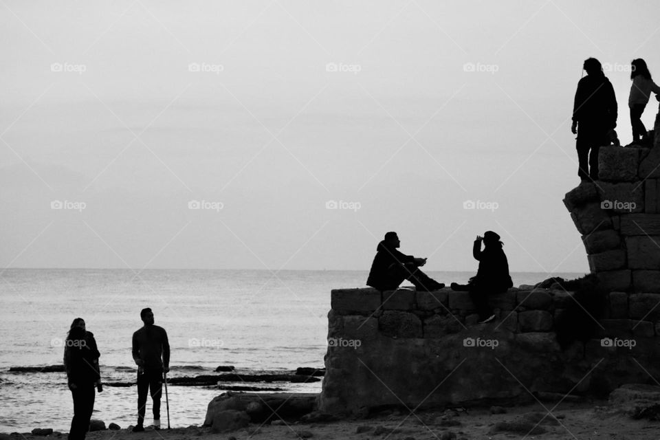 People silhouettes on the beach