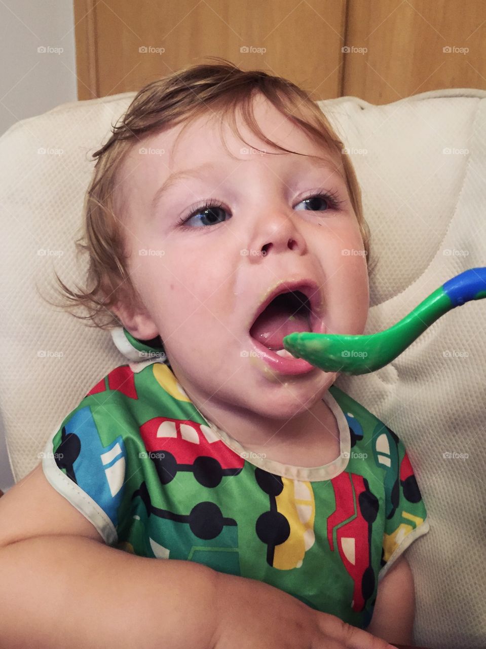 Little girl eating with spoon