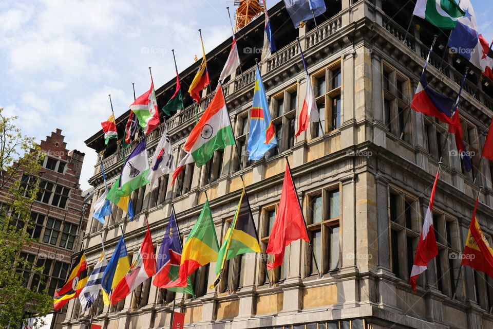 Many different colorful flags on the building in Antwerpen 