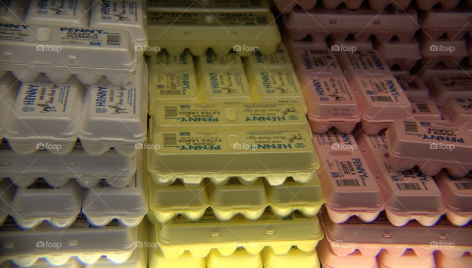 Dozens of Multi-Size Eggs Stacked on Retail Shelf