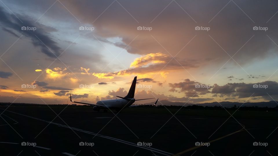 dramatic sunset behind aircraft