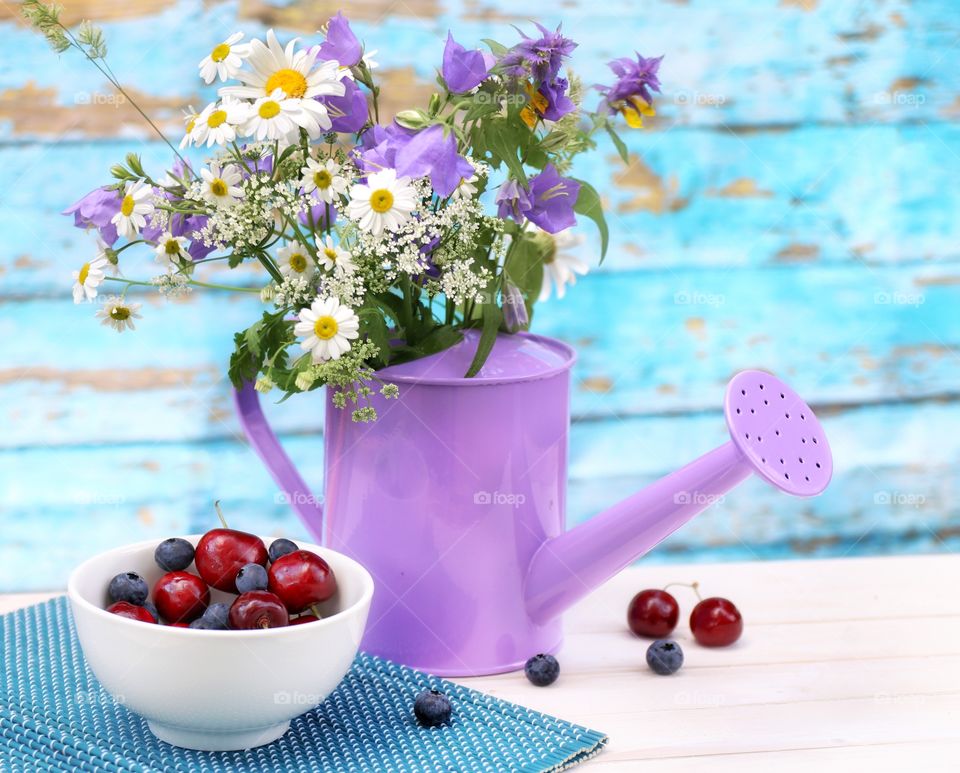 Summer bouquet of wild flowers and sweet cherry