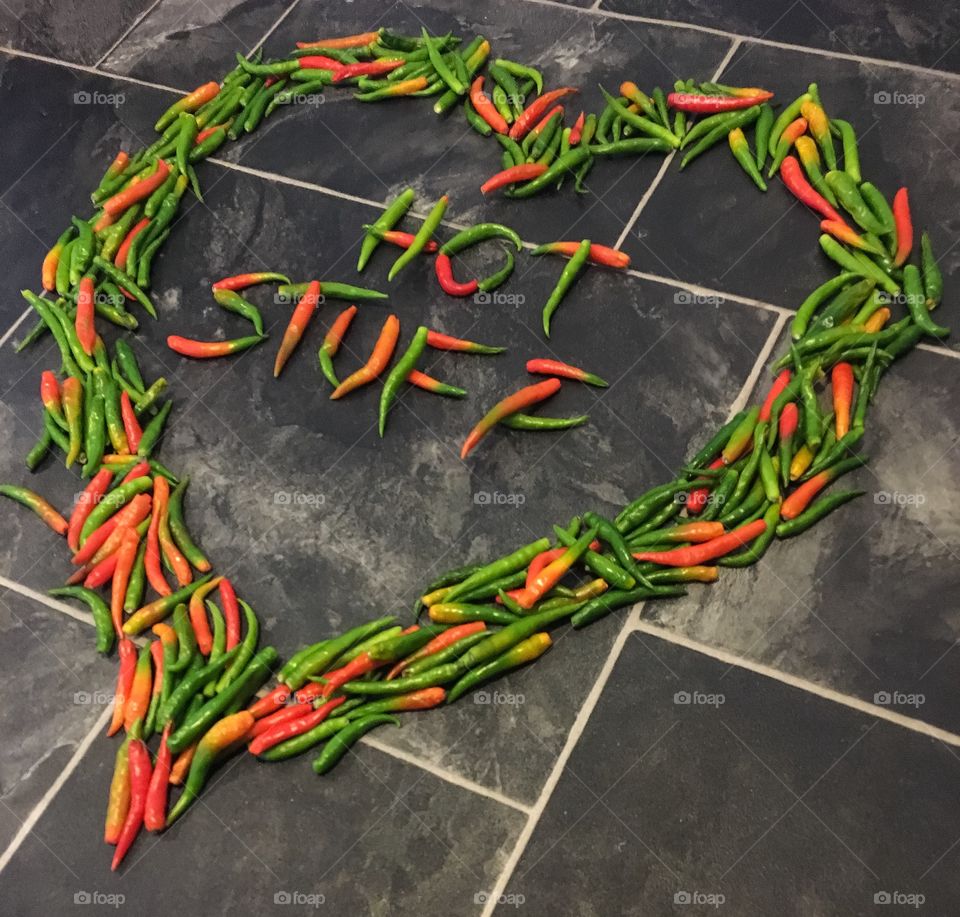 Fresh Chilli's Laid Flat In A Love Heart Shape Spelling Hot Stuff