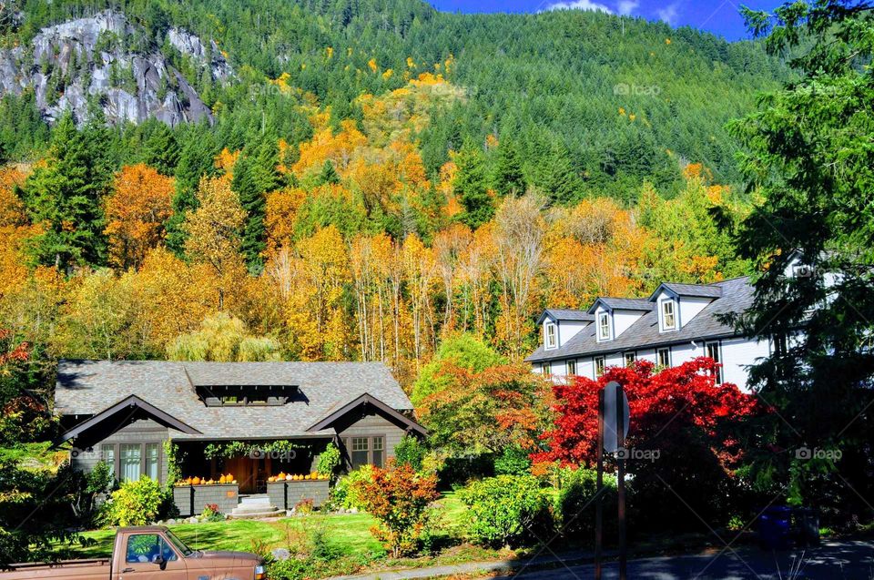 house and hotel against a beautiful autumn mountain