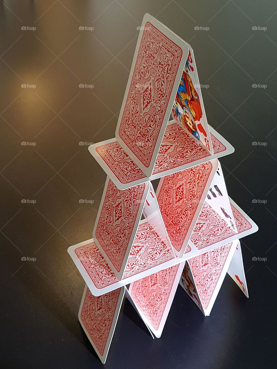 Triangel- house of playing cards stacked on top of euch other-  house of cards