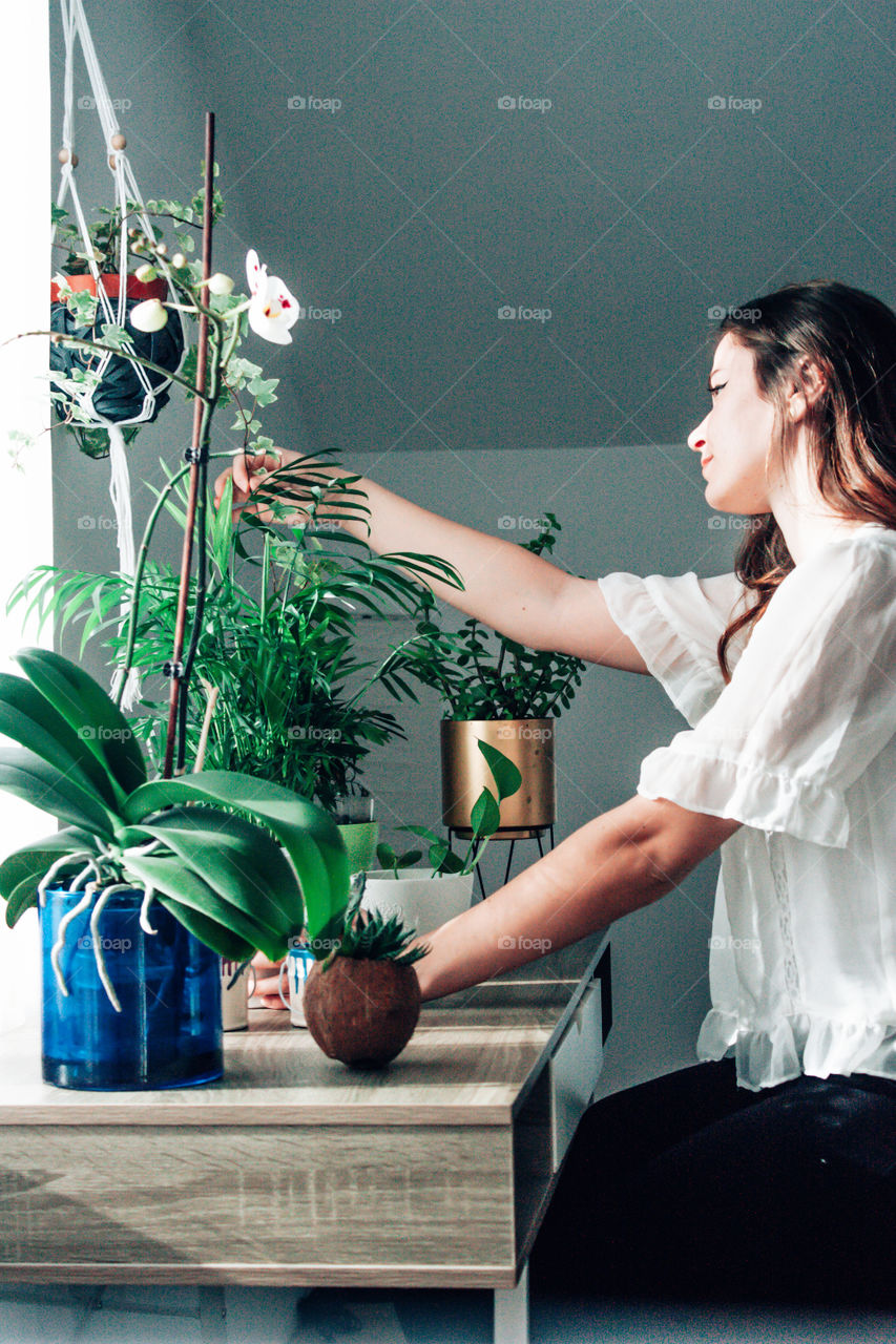 woman taking care of her beautiful flowers