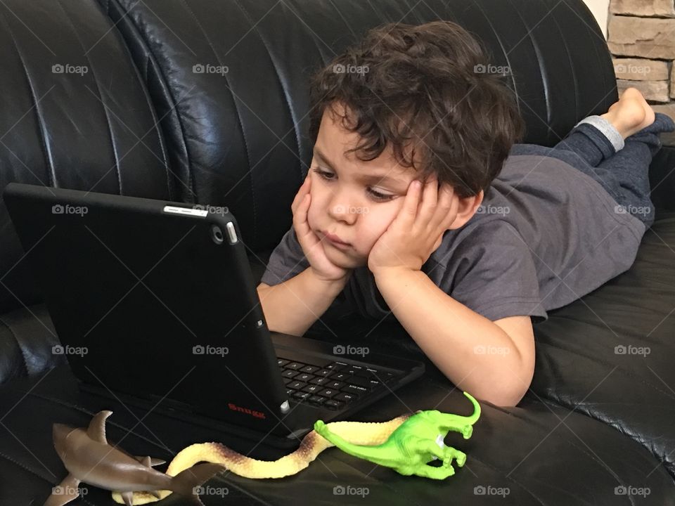 Boy watching a movie on an iPad