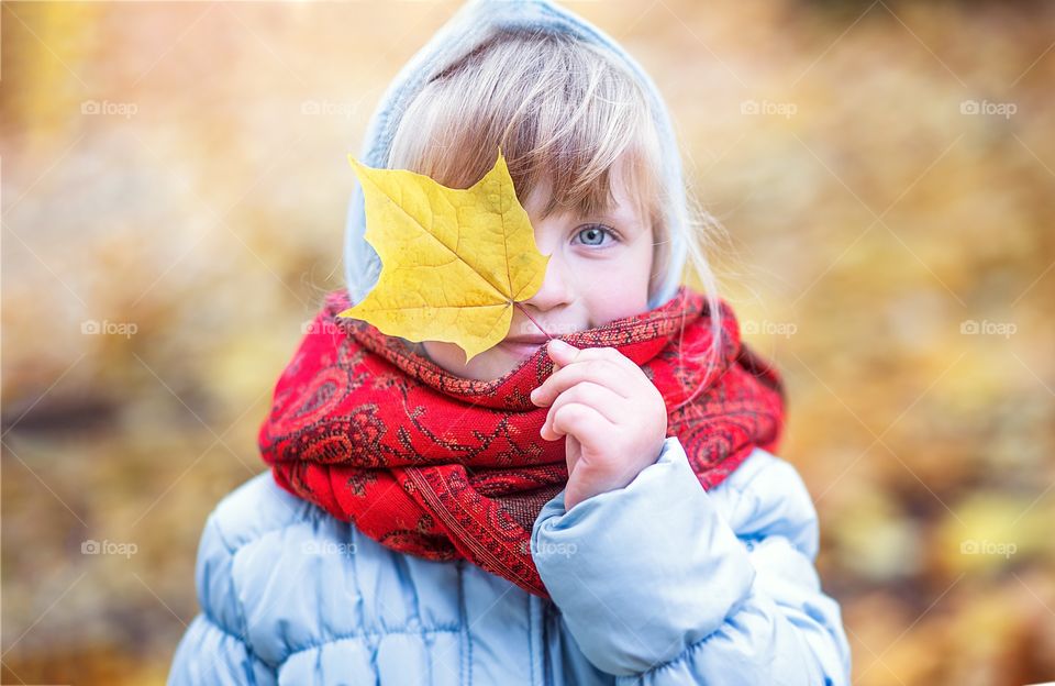 autumn portrait of a girl with a leaf