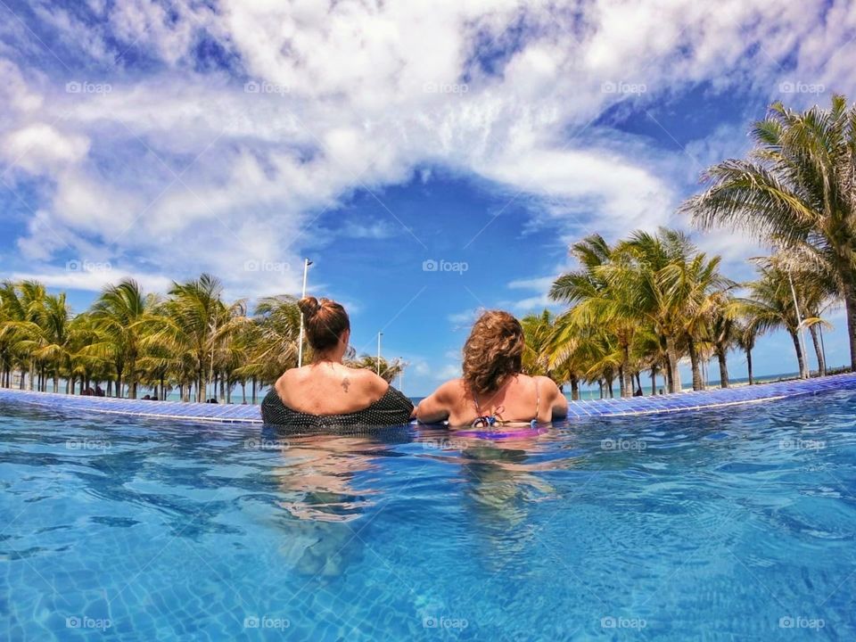Two female cousins ​​in the pool at the resort in Aquiraz, Brazil
