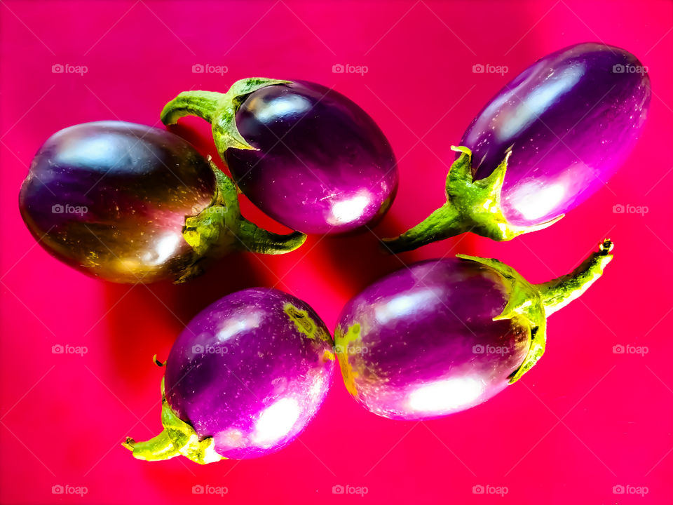 Fresh eggplant isolated on pink background with clipping path