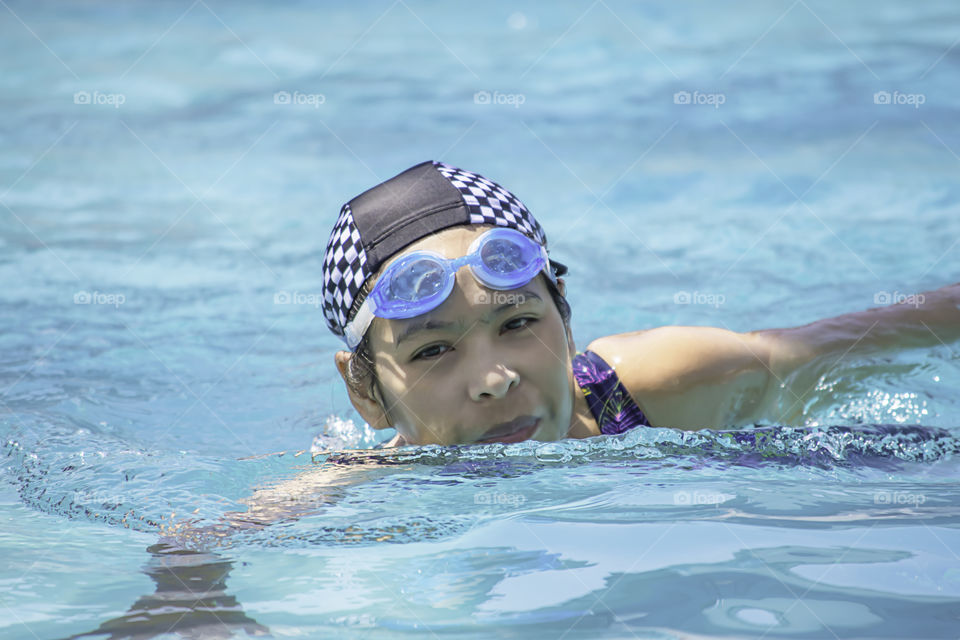 Asian women are swimming in the pool.