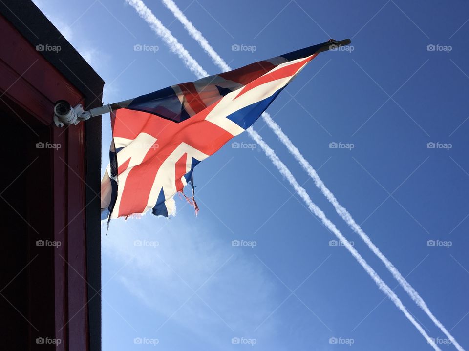 Union Jack Flag flapping in the slight breeze caught my eye whilst walking on the promenade ... it’s seen better days looking ragged and tatty now ... lovely contrast against a bright blue sky with two white plane contrails adding a touch of detail.