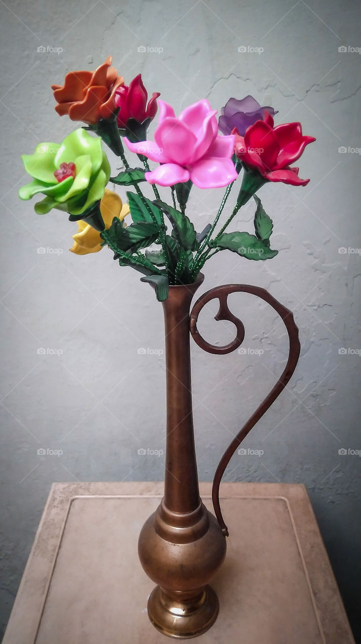 This is a picture A craft arranges plastic flowers which are put together using a wire.