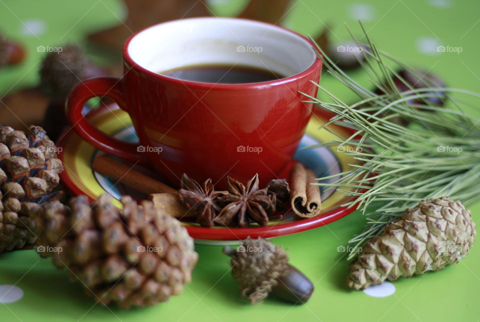 Red cup of coffee in the table, autumn still life