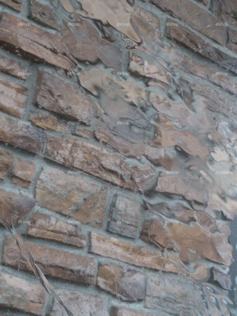 Brick Wall through a Rainy Window