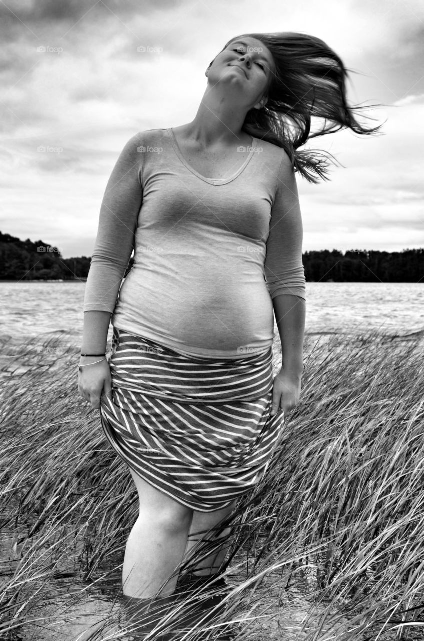 Beautiful woman standing in lake