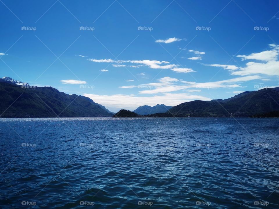 Sea view, mountain, blue sky and white clouds.