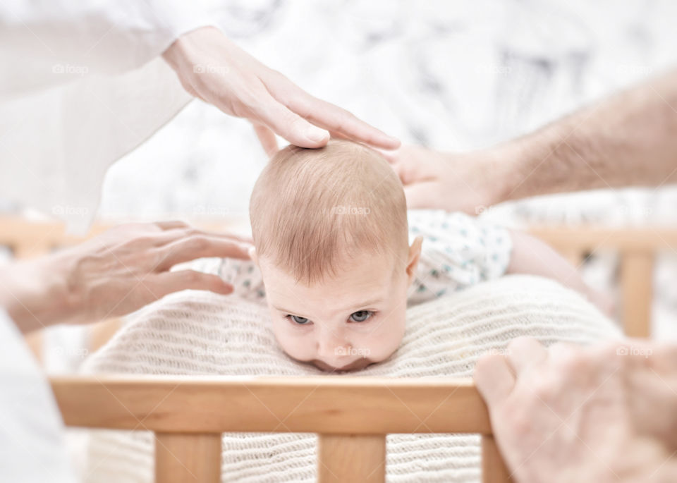 Close-up of hands stroking baby