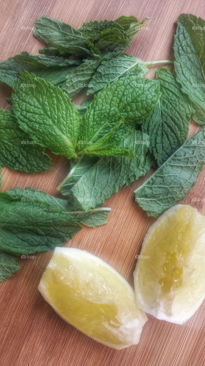 Mint and lemon on table