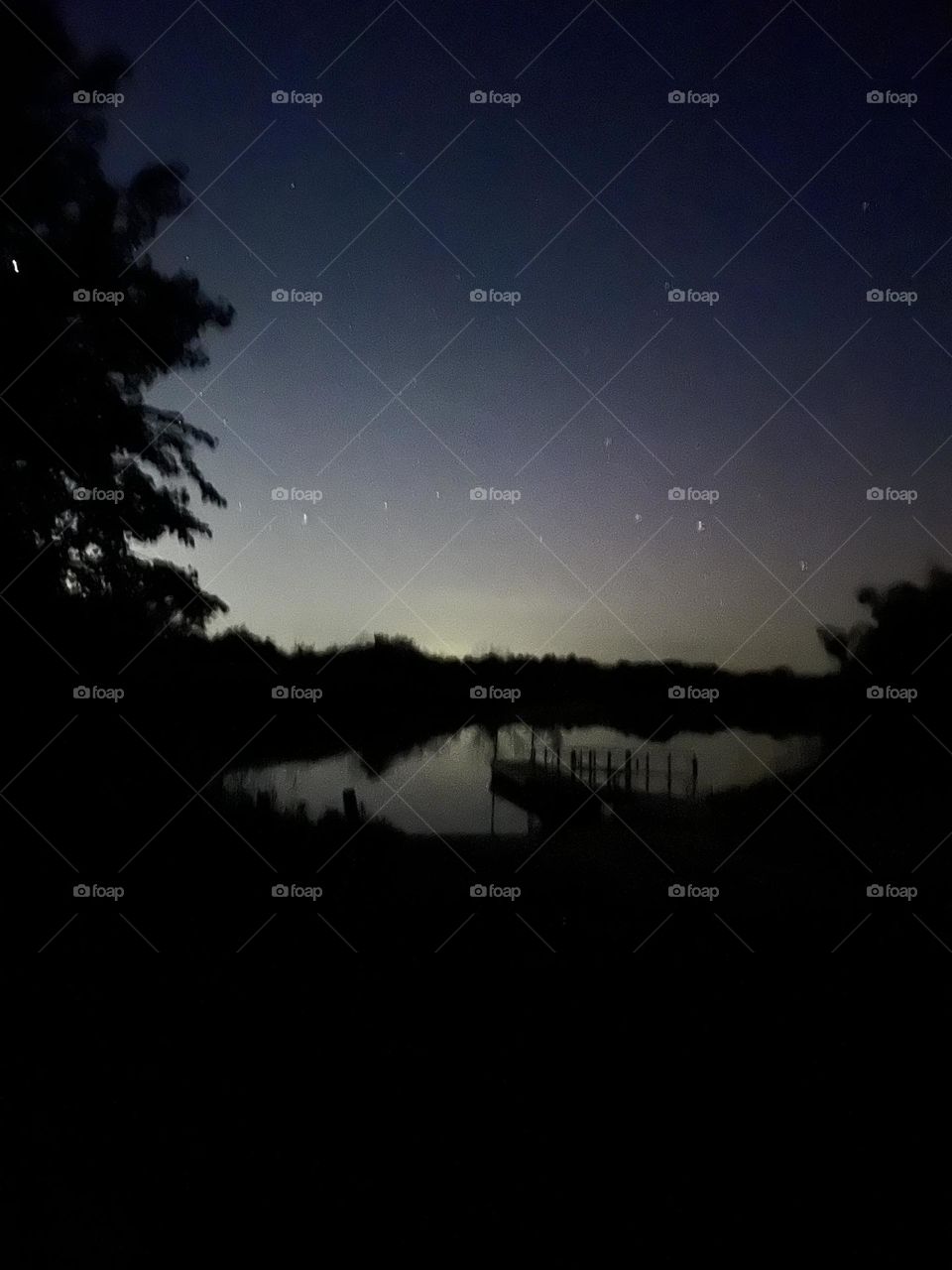 Night view of stars and boat ramp.