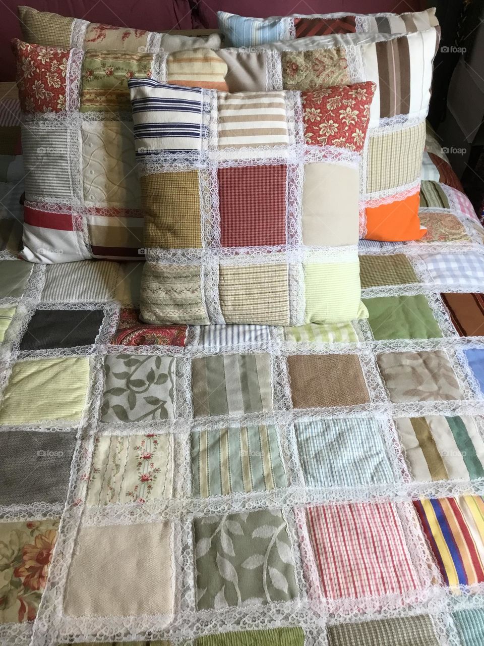 A patchwork quilt - a quilt in which the top layer may consist of pieces of fabric sewn together to form a design. Originally, this was to make full use of leftover scraps of fabric, but now fabric is often bought specially for a specific design.