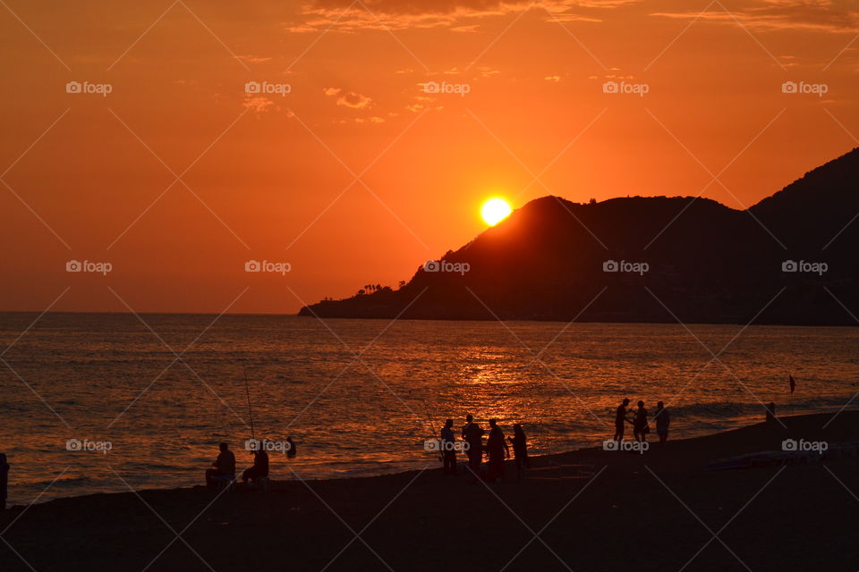 sun setting behind mountain