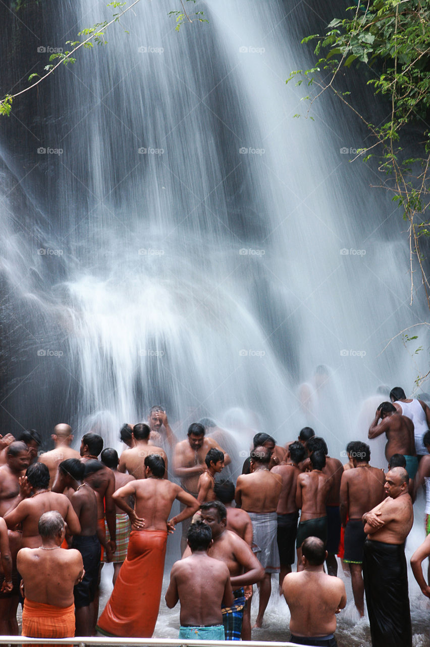 Devotees taking bath at Hogenakkal Falls, India