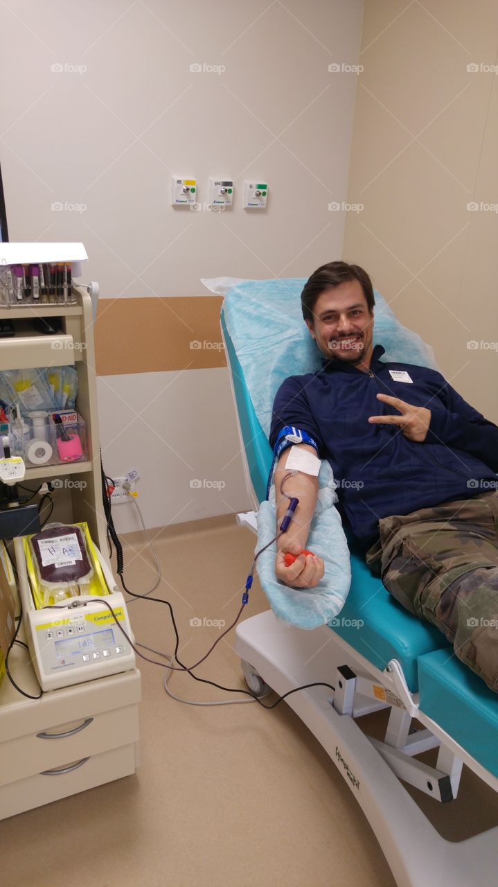 Blood donor at donation with a bouncy ball holding in hand