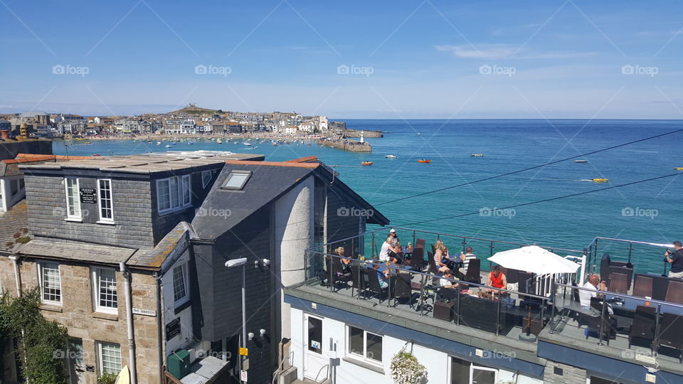Harbor in St Ives with people on restaurant roof
