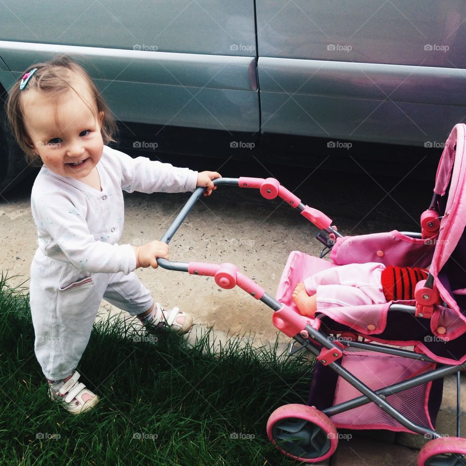 Baby girl standing near scrolled