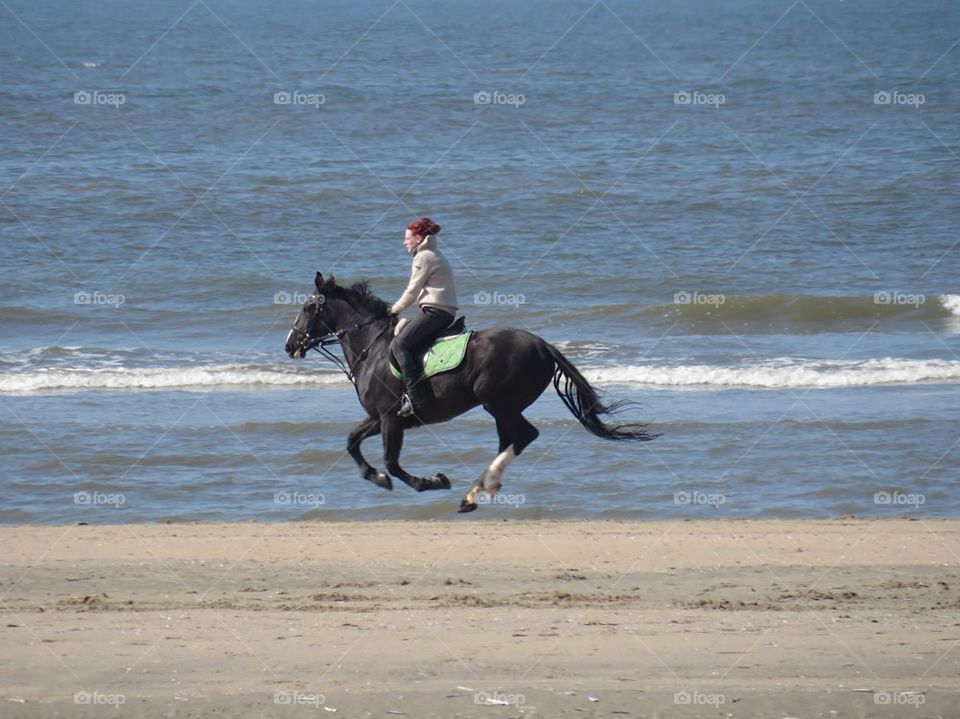 Riding down the beach