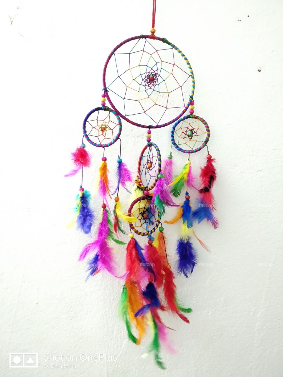 Dream catcher.....  a small hoop containing a horsehair mesh decorated with feathers and beads, believed by American Indians to give its owner good dreams.