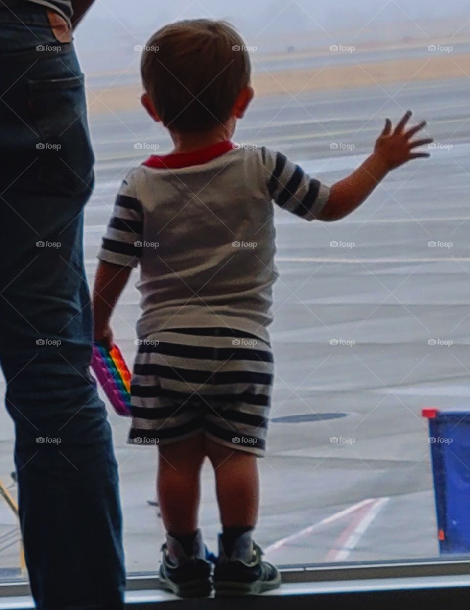 little boy watching planes take off