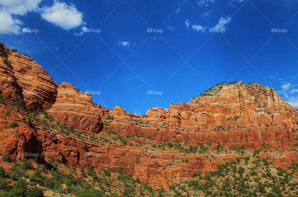 shades of orange on the rock formation with blue sky as background