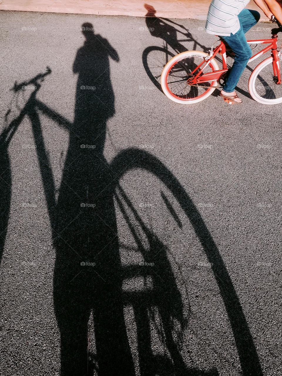 Me and my sin riding the bicycle in the neighborhood against bright evening sun