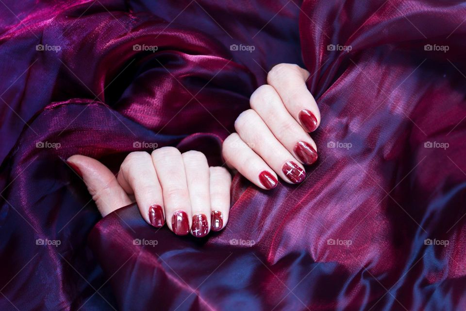 Hands with beautiful manicure in magenta color