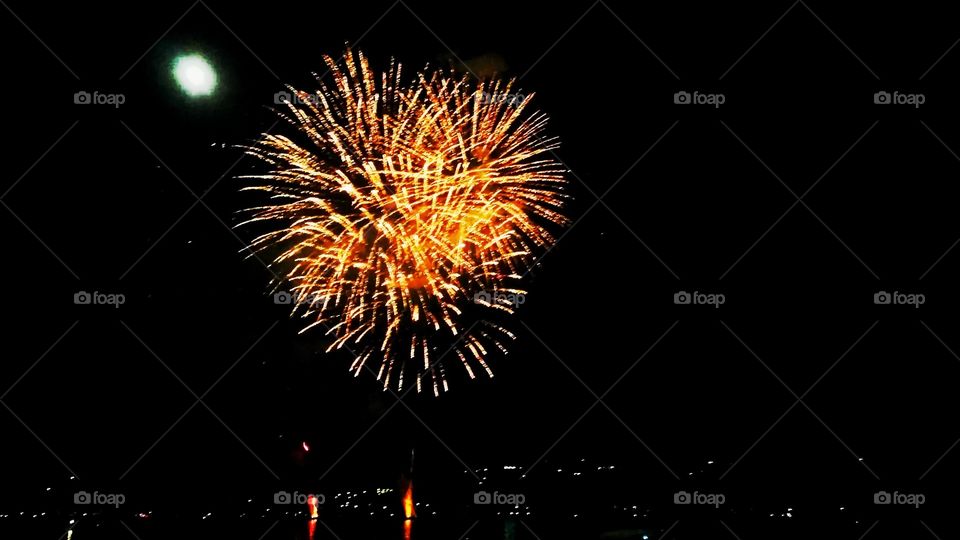 Golden fireworks, with full moon