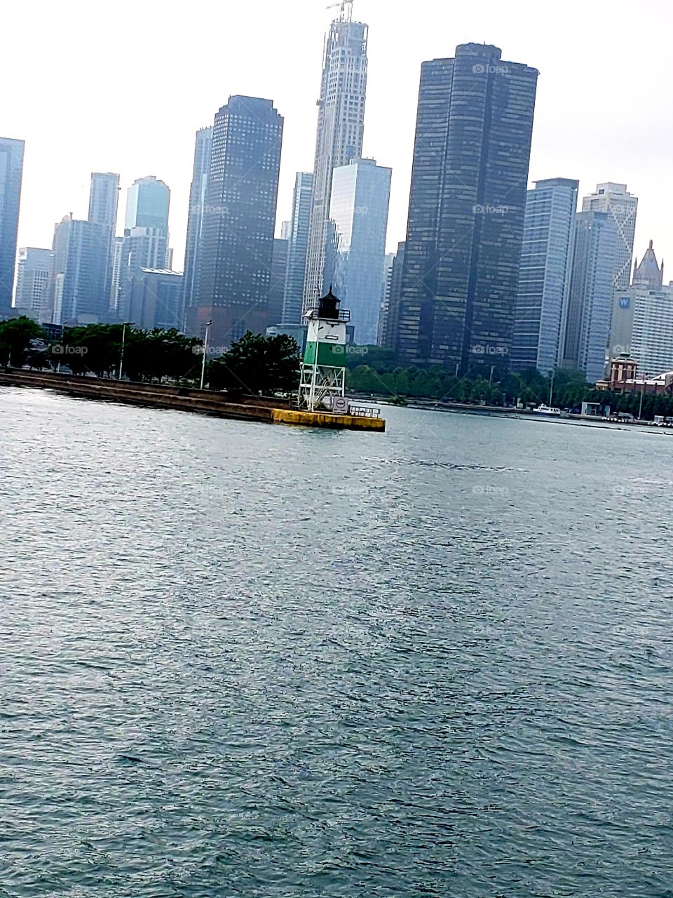View of foggy downtown Chicago from Lake Michigan and a small lighthouse