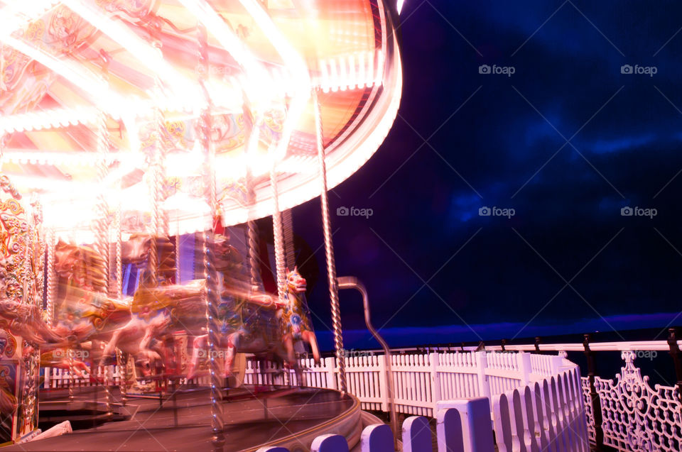 Brighton pier carousel. Light motion blur photograph. 