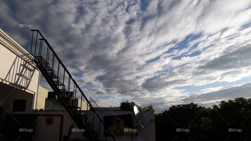 Waves in the sky bring movement and drama to a everyday scene.