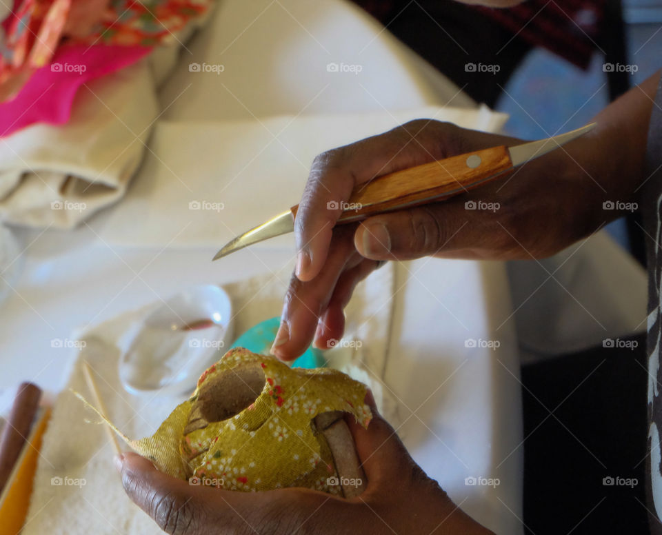 Hands of a doll maker.