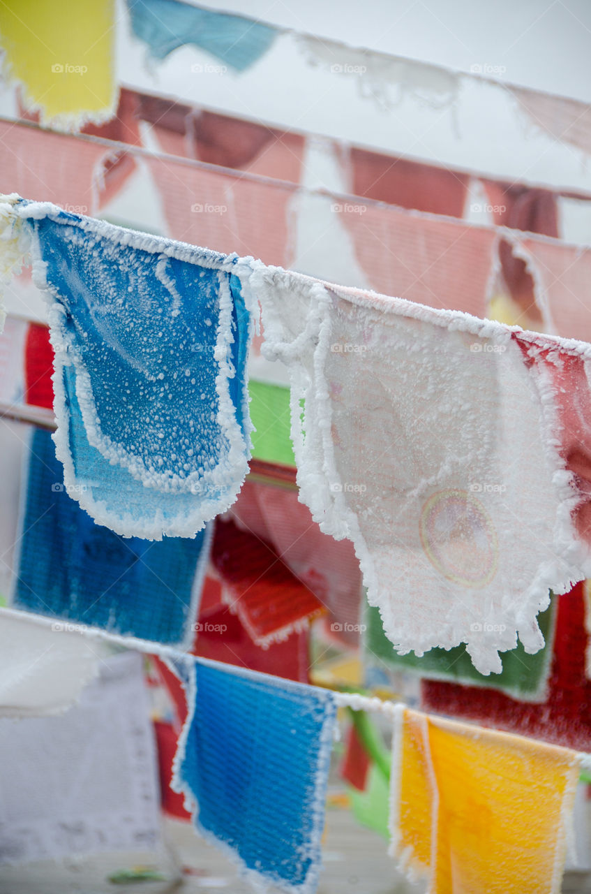 Frozen prayer flags at the top of XueBao mountain, Sichuan, china (5588m) this mountain is on the western part of the Tibetan plateau and considered sacred by the many Tibetan locals 