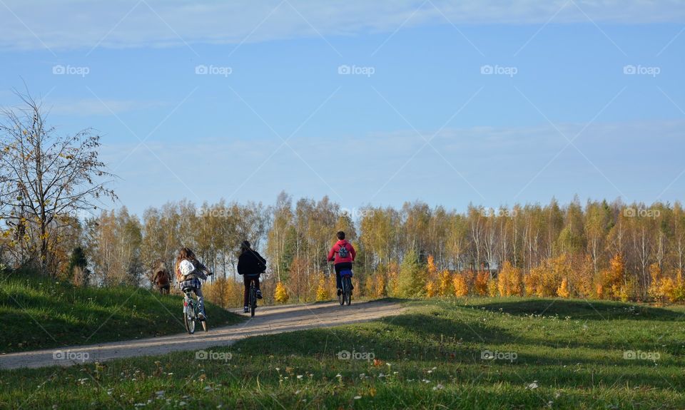 people riding on a bikes autumn beautiful landscape